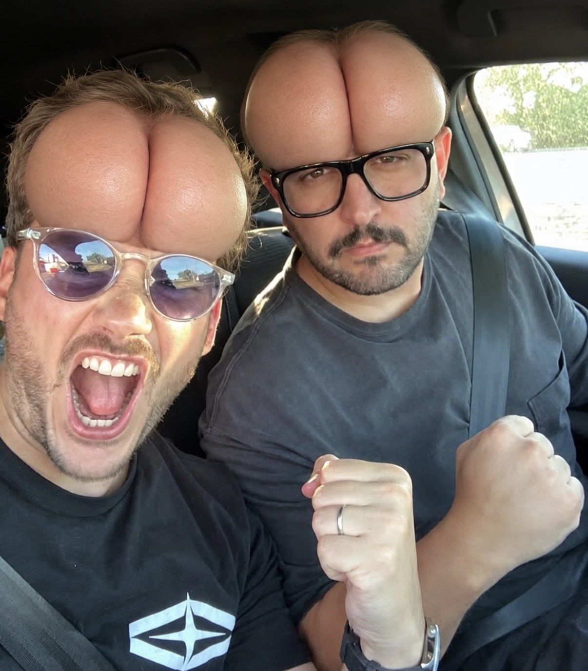 Two people in a car with digitally altered rounded foreheads.