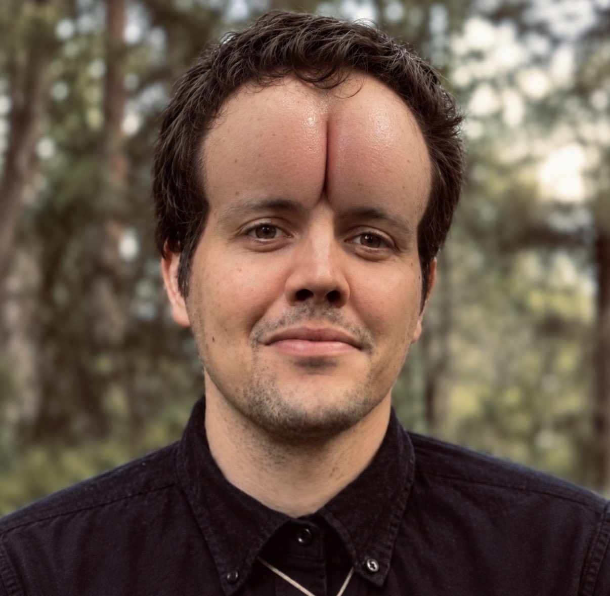 An outdoor portrait with a digitally altered split forehead.