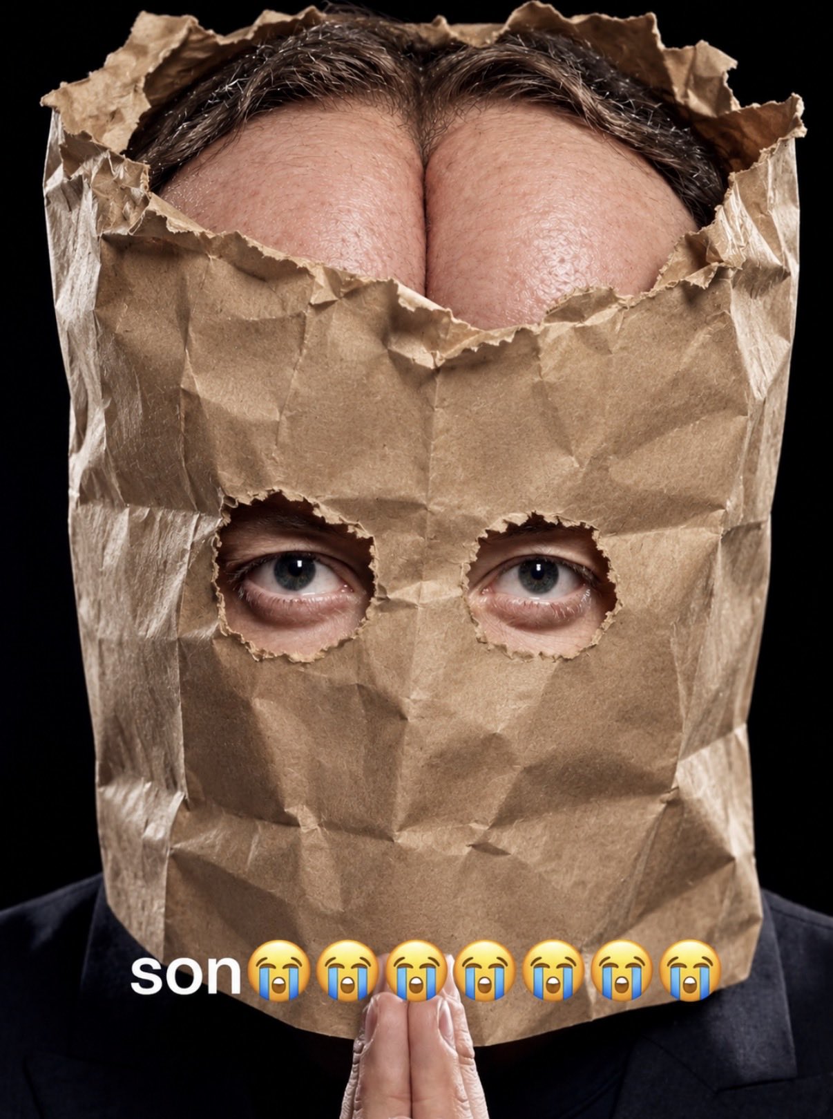 A face peering through a paper bag with surreal rounded forms above the eyes.